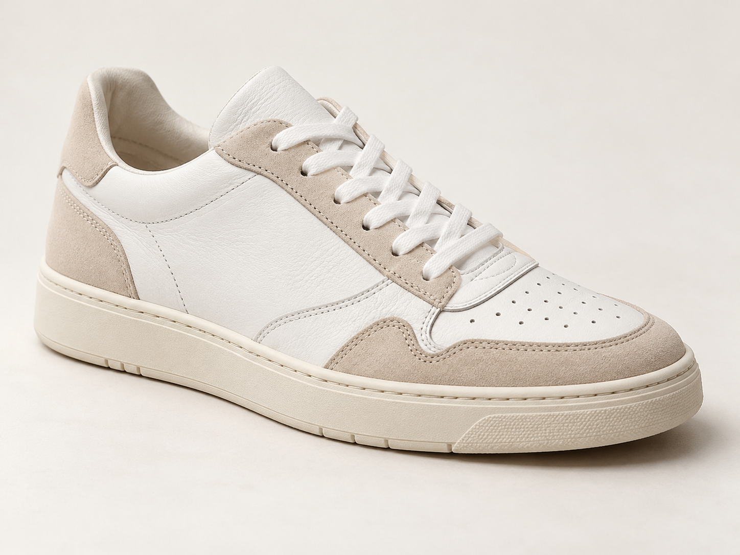 Raw studio capture of white sneaker footwear on studio pedestal